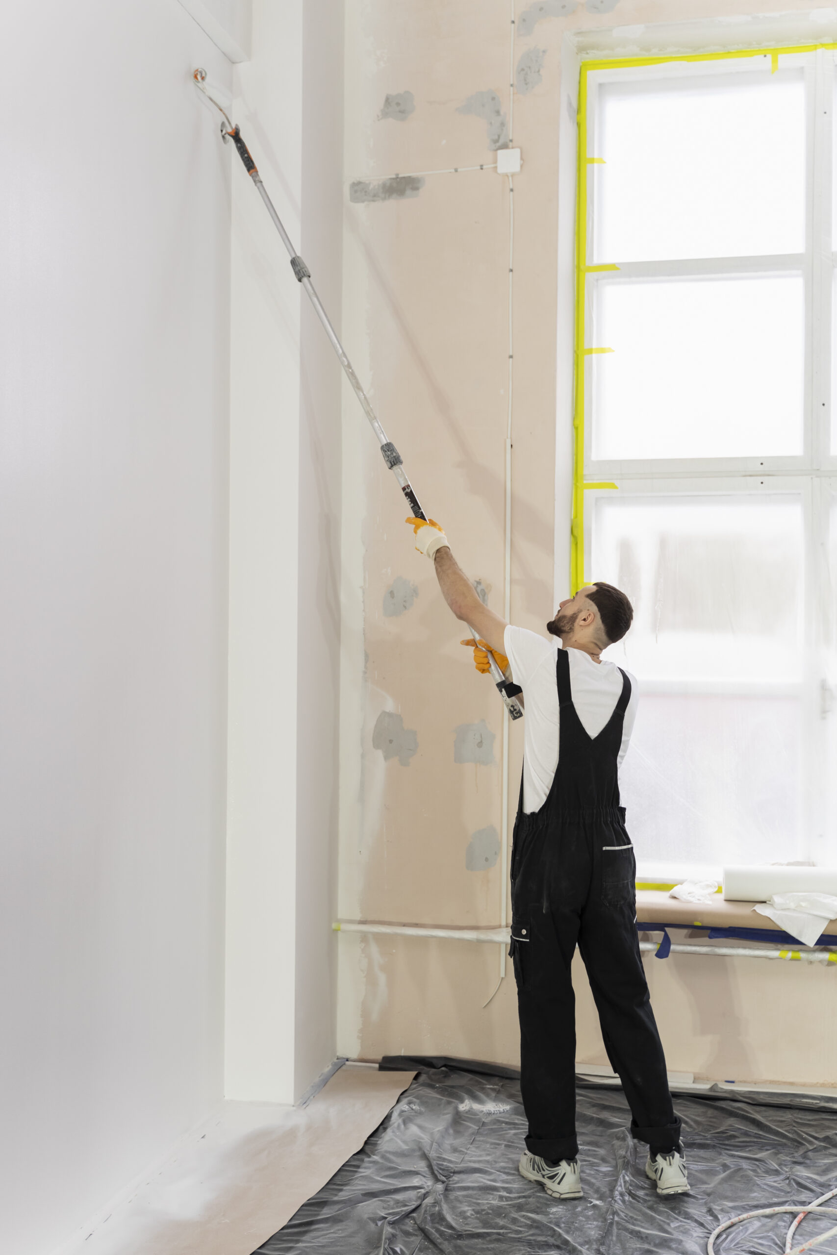 full shot young man painting wall
