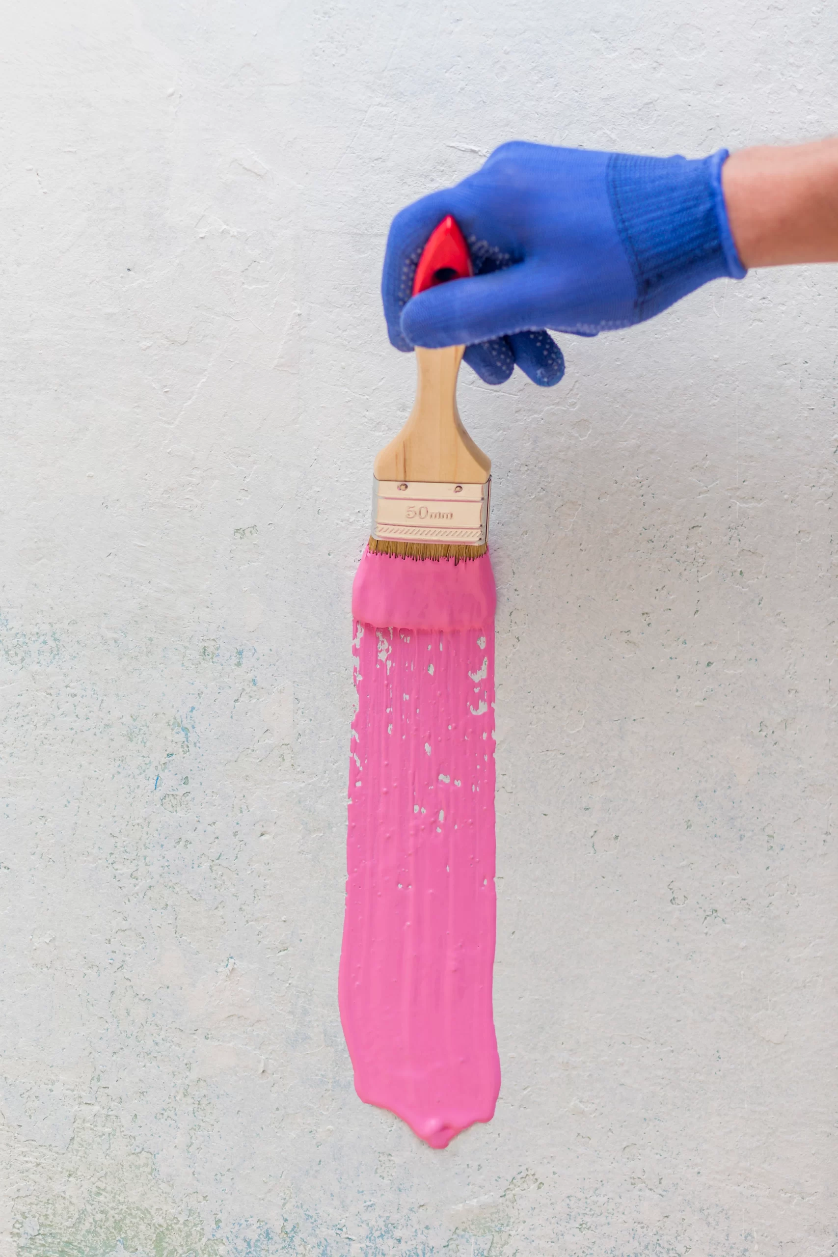 top view hand holding brush with pink paint